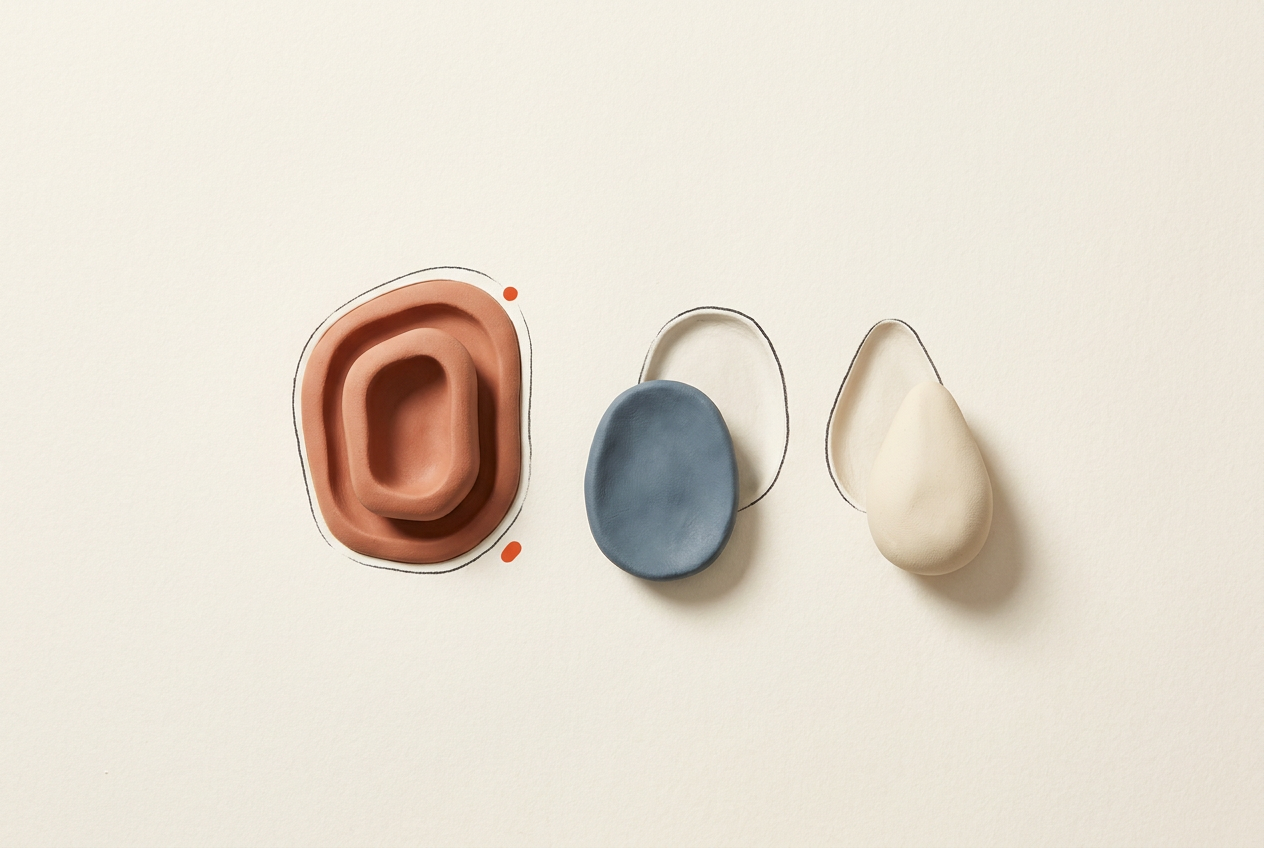 One clay piece fills its matching indentation, demonstrating how two nearby pieces could fit into the remaining spaces.
